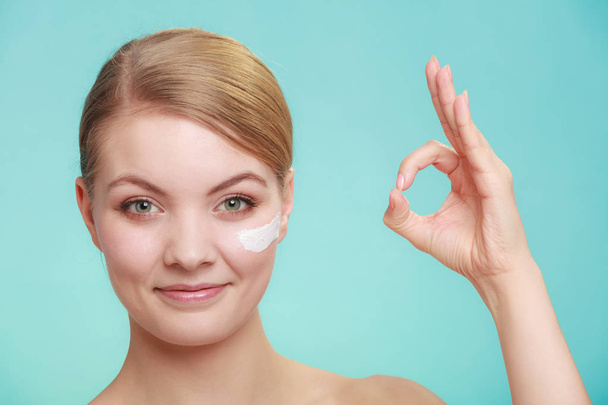 woman applying cream on her skin face. - Foto, Imagem