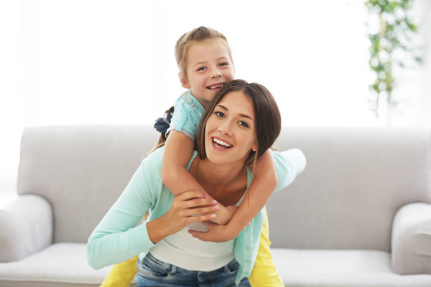 Cute girl with mother at home - Foto, imagen