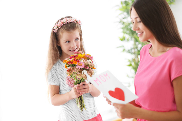 Greetings from daughter with flowers. Mothers day concept - Фото, изображение