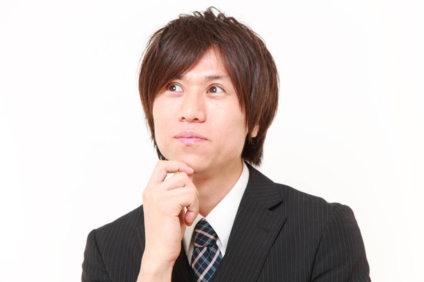 young Japanese businessman thinks about something - Photo, Image