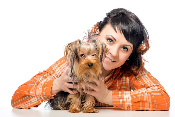 Happy woman posing with her Yorkshire terrier on a white backgro - Fotografie, Obrázek