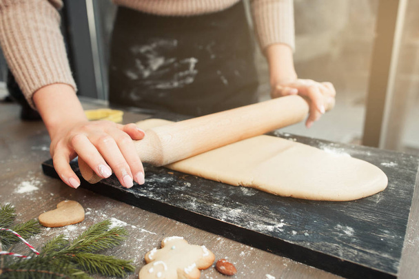Close-up of hands rolling out dough - 写真・画像