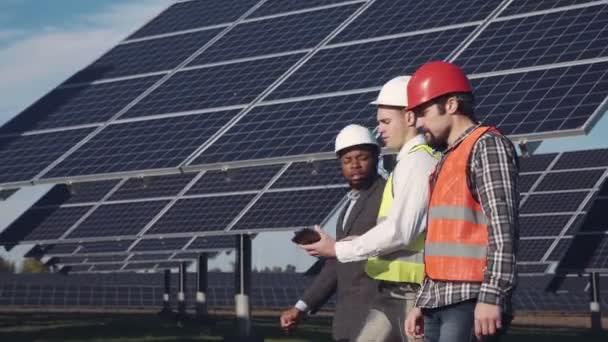 Three professionals in solar power station. - Imágenes, Vídeo
