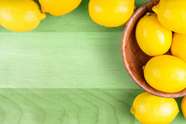 lemons on wooden table - Фото, изображение