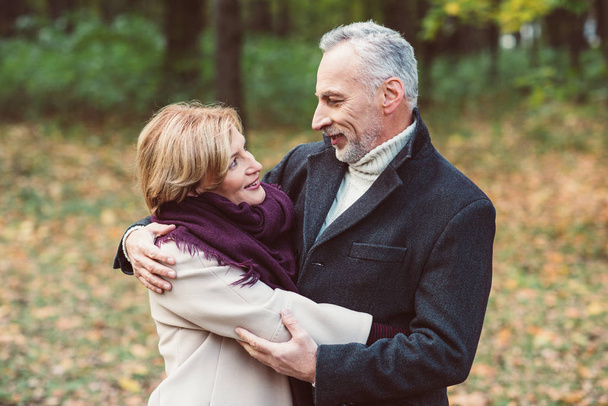 Mature couple embracing in park - Photo, image