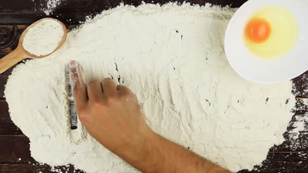 Top view Young man writes a word food on white flour at wooden desk from above. - Footage, Video