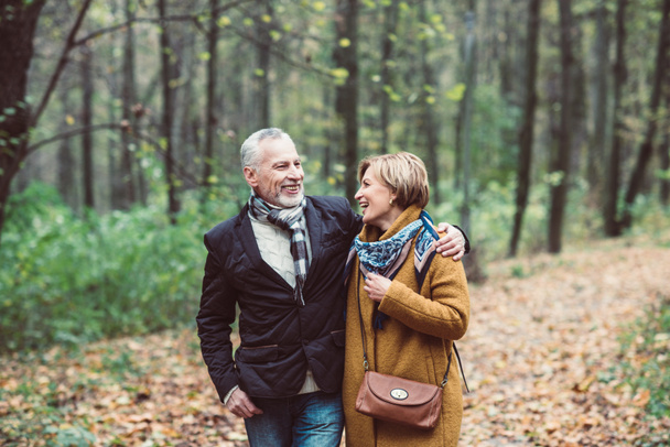 Mature couple walking in autumn park - Photo, Image