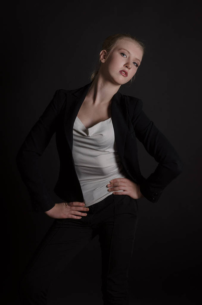 Beautiful blonde woman in a severe  business suit - Фото, изображение