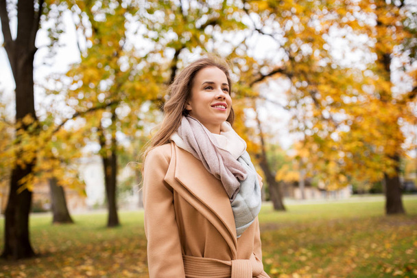 beautiful happy young woman walking in autumn park - Photo, image