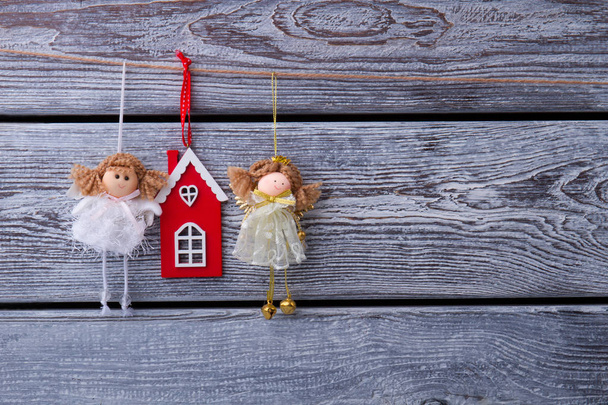 Beautiful fabulous fairies and red house hanging on a wooden fen - Fotó, kép
