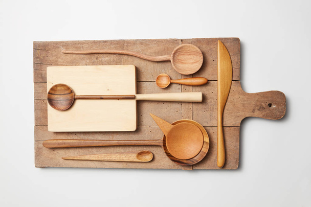 Various kitchen utensil on white wooden background - Fotó, kép