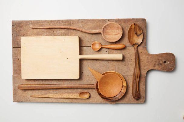 Various kitchen utensil on white wooden background - Zdjęcie, obraz