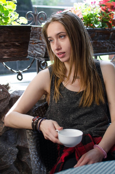 Young woman is drinking coffee - Fotó, kép