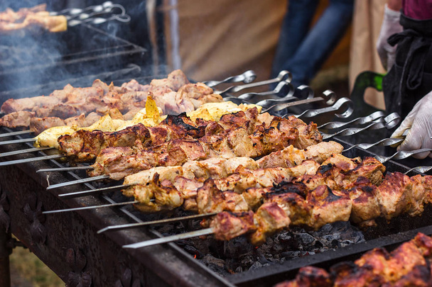 Marinated shashlik preparing on a barbecue grill over charcoal. Shashlik or Shish kebab popular in Eastern Europe. Shashlyk (skewered meat) was originally made of lamb. Roast Beef Kebabs On BBQ Grill. - Photo, Image