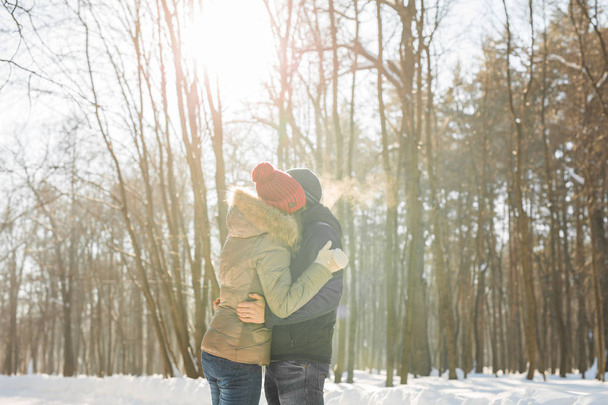 people, season, love and leisure concept - happy couple outdoors in winter - 写真・画像