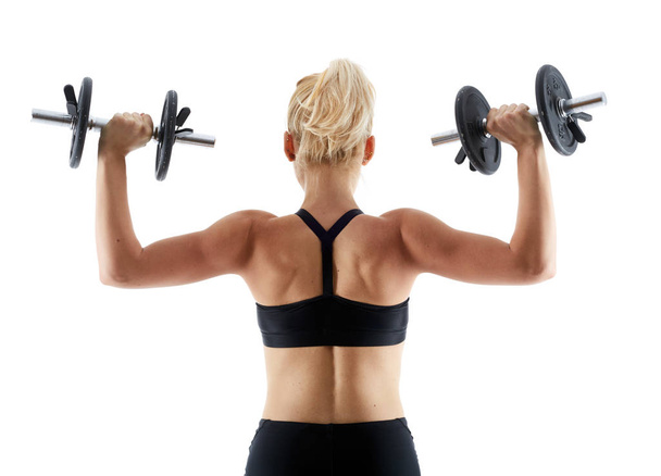 Fitness girl doing shoulder workout with dumbbells - Foto, Imagen