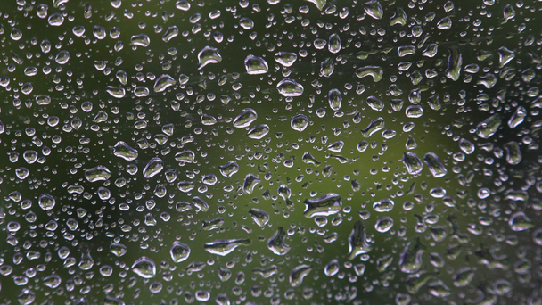 Close up image of rain drops falling on a window , ULTRAHD 4k, real time - Footage, Video