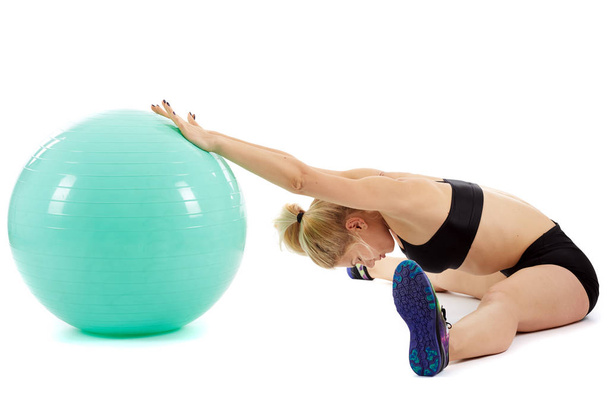 Fitness girl working with gym ball - Photo, image