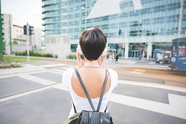 woman with backpack listening music - Photo, Image