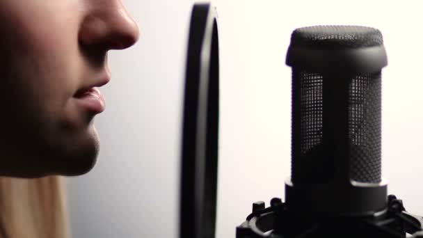 Woman profile singing into studio microphone - Footage, Video