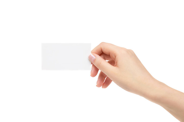 Female hand holds white card on a white background. - Photo, image