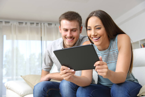 Couple enjoying media content in a tablet - Foto, Bild