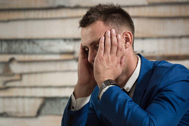 Tired business man at workplace in office holding his head on ha - Photo, Image