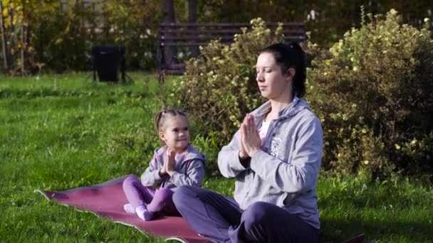 Mother and daughter meditating together - Footage, Video
