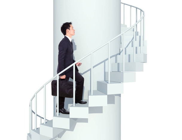 business man going upstairs in a curved staircase to success - Photo, Image