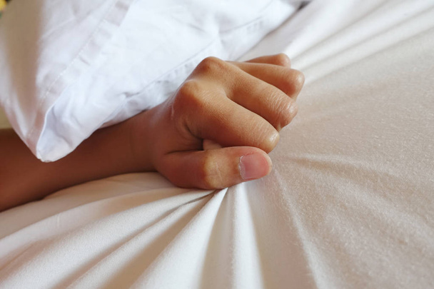 hand of women pulling white sheets in ecstasy, orgasm. - Zdjęcie, obraz