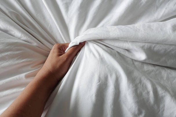 hand of women pulling white sheets in ecstasy, orgasm. - Φωτογραφία, εικόνα