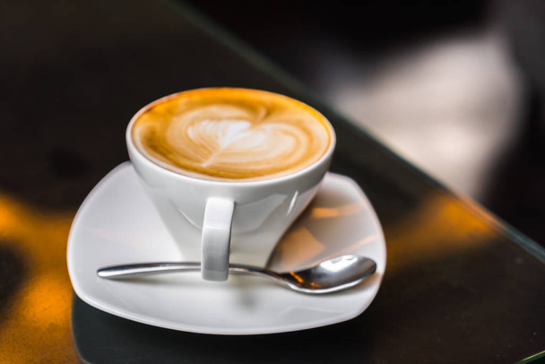 Latte Coffee art on the table . - Φωτογραφία, εικόνα
