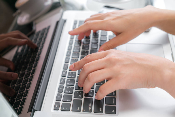 Closeup of business woman hand typing on laptop keyboard . - Foto, immagini