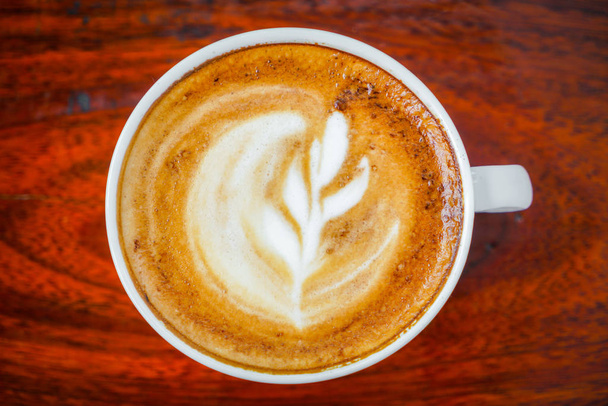 Latte Coffee art on the wooden table . - Foto, Bild