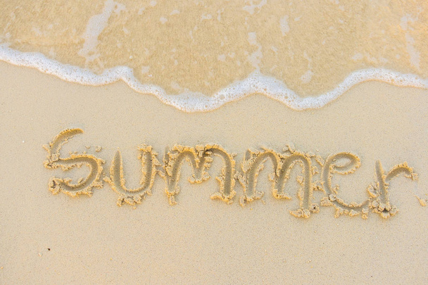 Summer text with white sandy beach and sea . - Fotó, kép