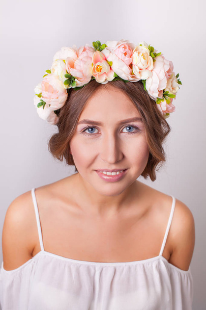 Beautiful girl in wreath of flowers closeup - Фото, зображення