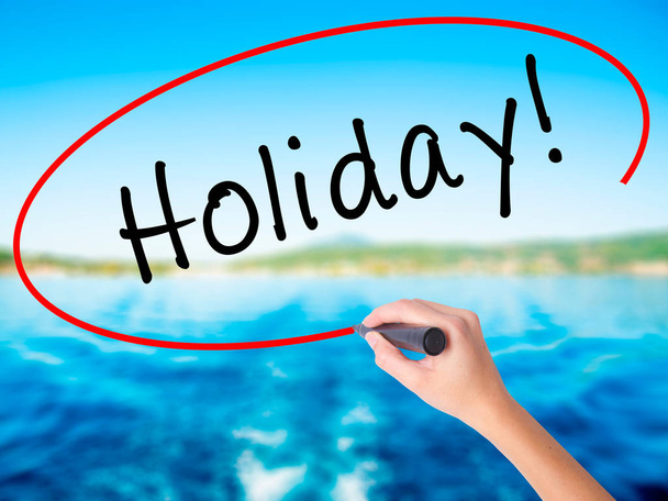 Woman Hand Writing Holiday! with a marker over transparent board - Photo, Image
