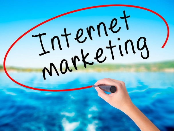 Woman Hand Writing Internet marketing with a marker over transpa - Photo, Image