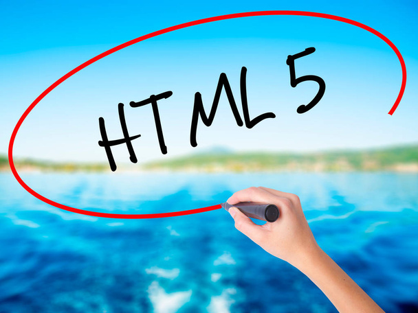 Frau schreibt HTML 5 mit Filzstift über transparente Tafel - Foto, Bild