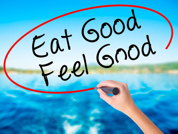 Woman Hand Writing Eat Good Feel Good with a marker over transpa - Photo, Image