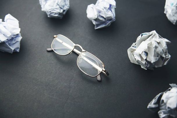 crumpled  paper and glasses - 写真・画像