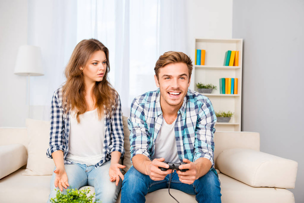 Young family with disagreements. Husband playing video games - Valokuva, kuva