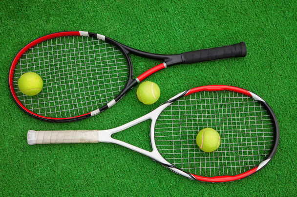 tennis racket with balls on green grass - Fotó, kép