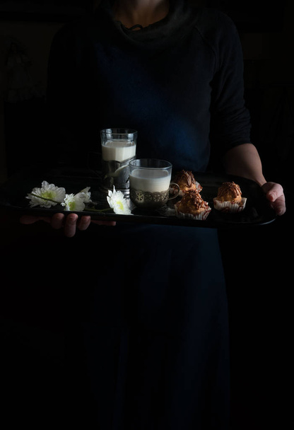still life in the small Dutch-style. womans hands holding a tray. cakes and milk. vintage - Foto, afbeelding