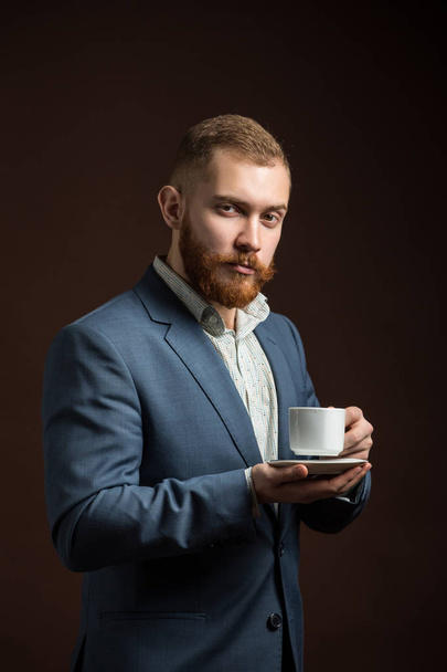 Elegant bearded man with cup of coffee - Foto, Bild