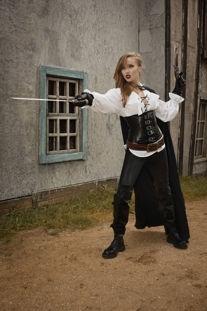 Sexy woman in pirate style holding sword - Foto, Imagem