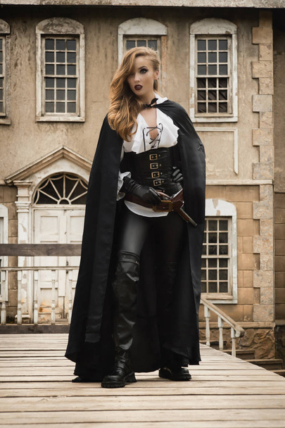 Sexy woman in pirate style with old handgun - Photo, Image