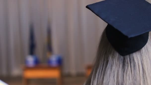 Blonde woman in academic cap, female ready to receive higher education diploma - Filmati, video