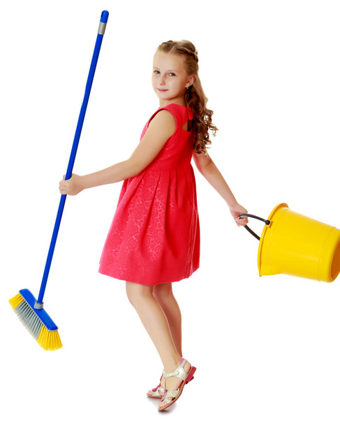 Little girl with bucket and brush cleans the house. - Zdjęcie, obraz