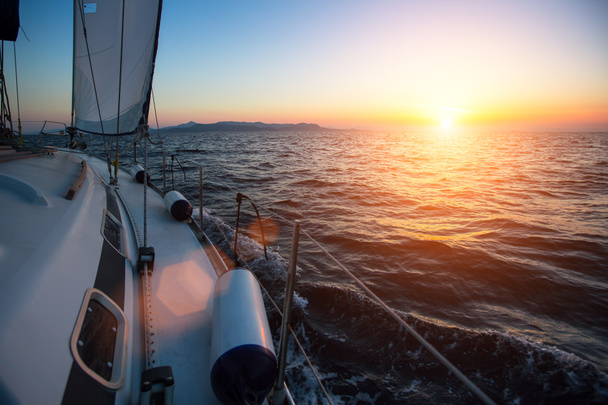 Yacht sailing against sunset - Photo, Image
